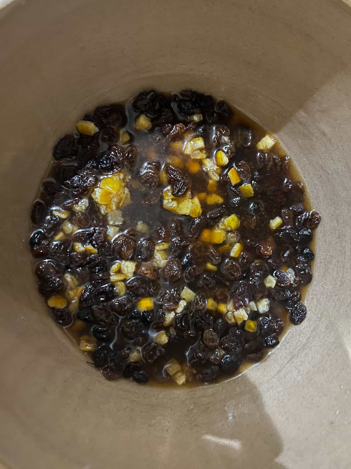 hot tea added to dried mixed fruit in a bowl