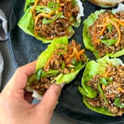 tofu in a lettuce wrap topped with grated carrot