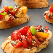 bruschetta topped with tomatoes and fresh basil.