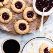 vegan thumbprint cookies with jam on a plate