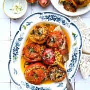 baked greek stuffed tomatoes and peppers in a dish