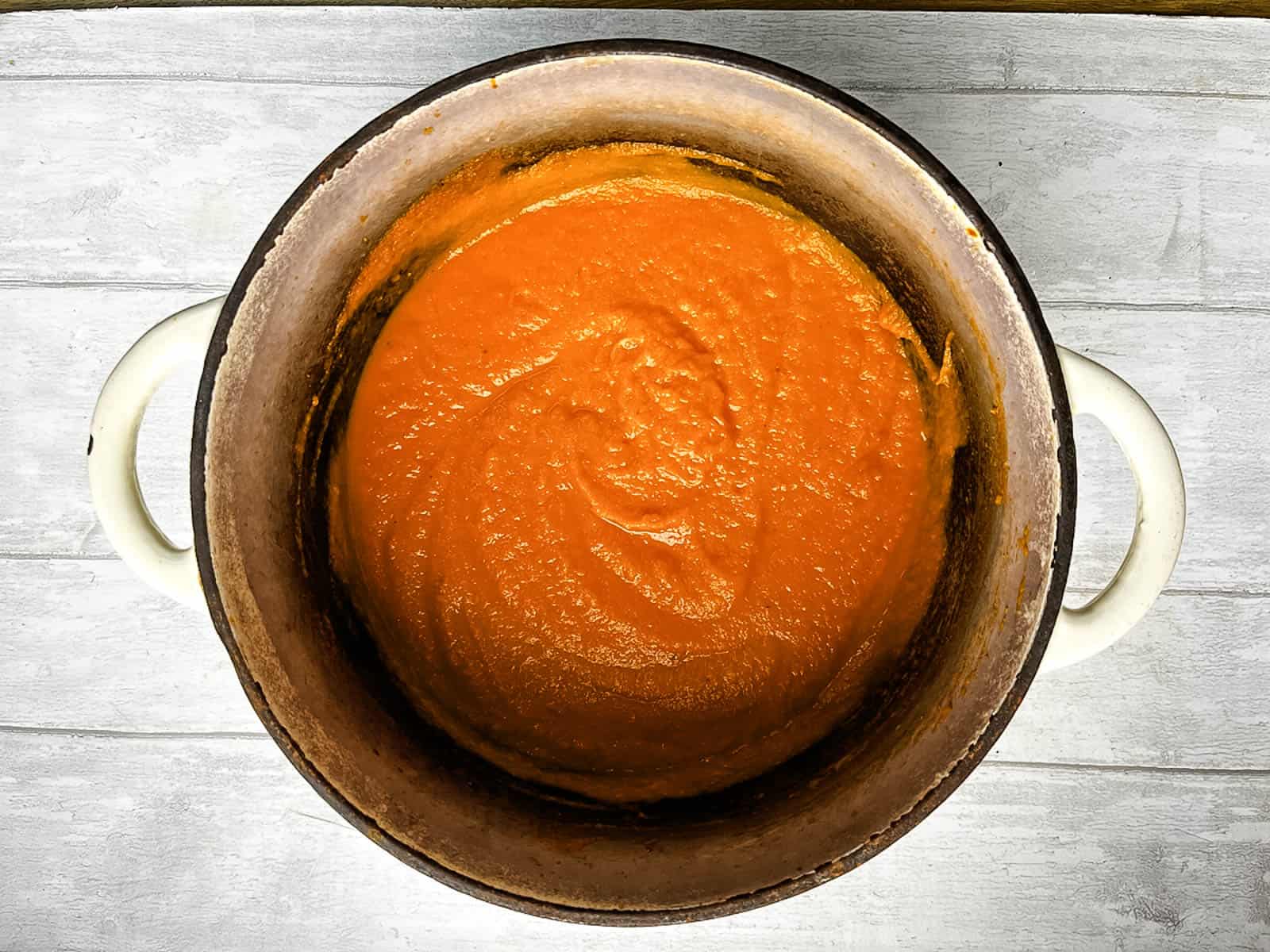 carrot and red pepper soup blended in a dutch oven