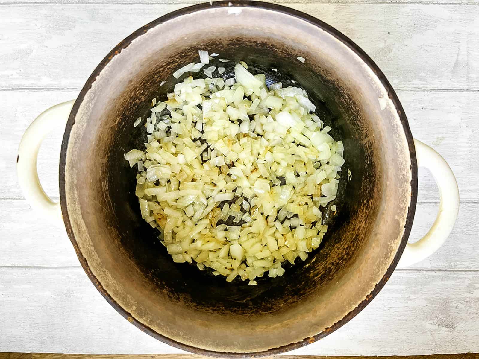 diced onion frying in a crock pot
