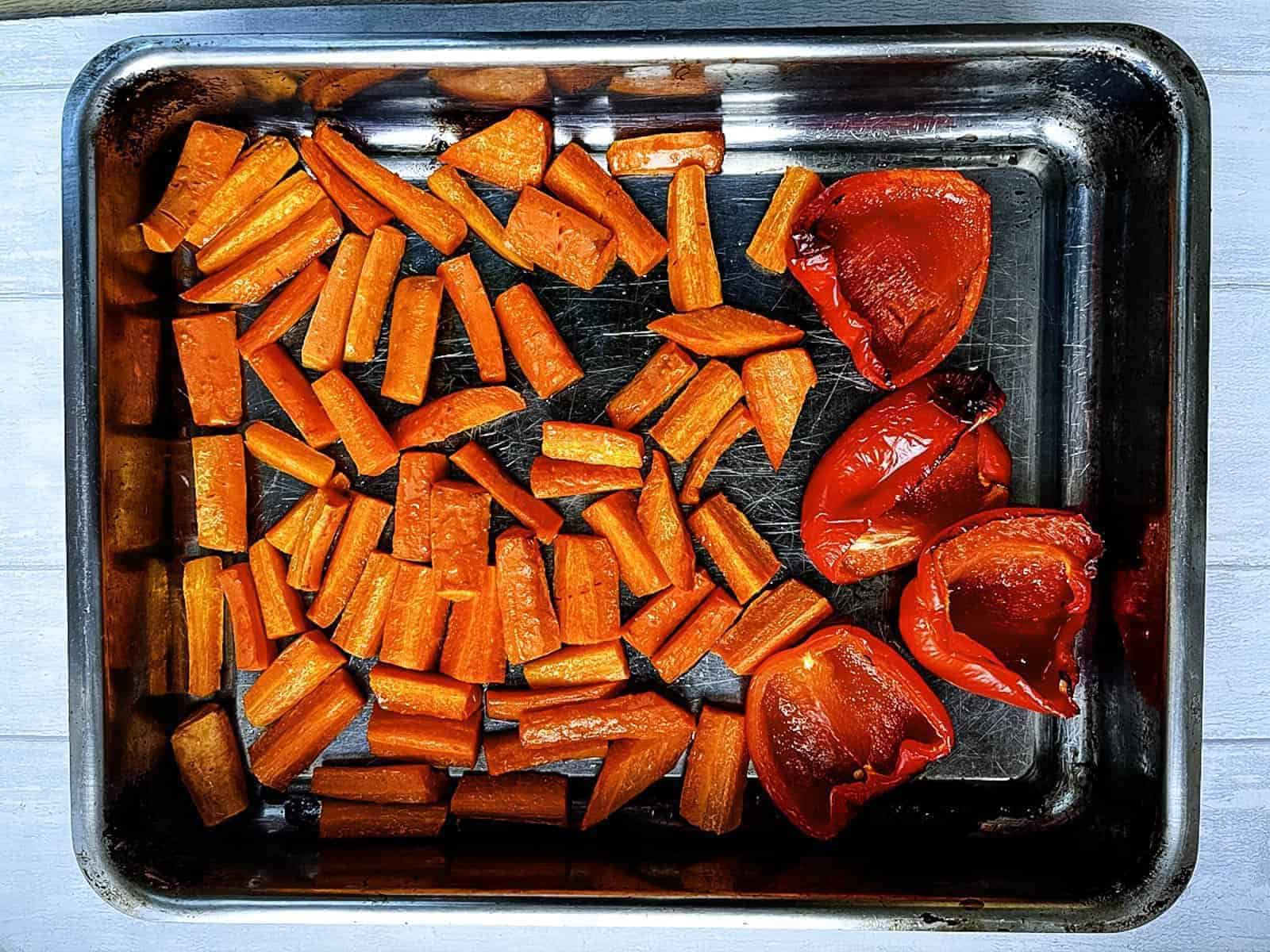 roasted carrots and red bell peppers in roasting tray