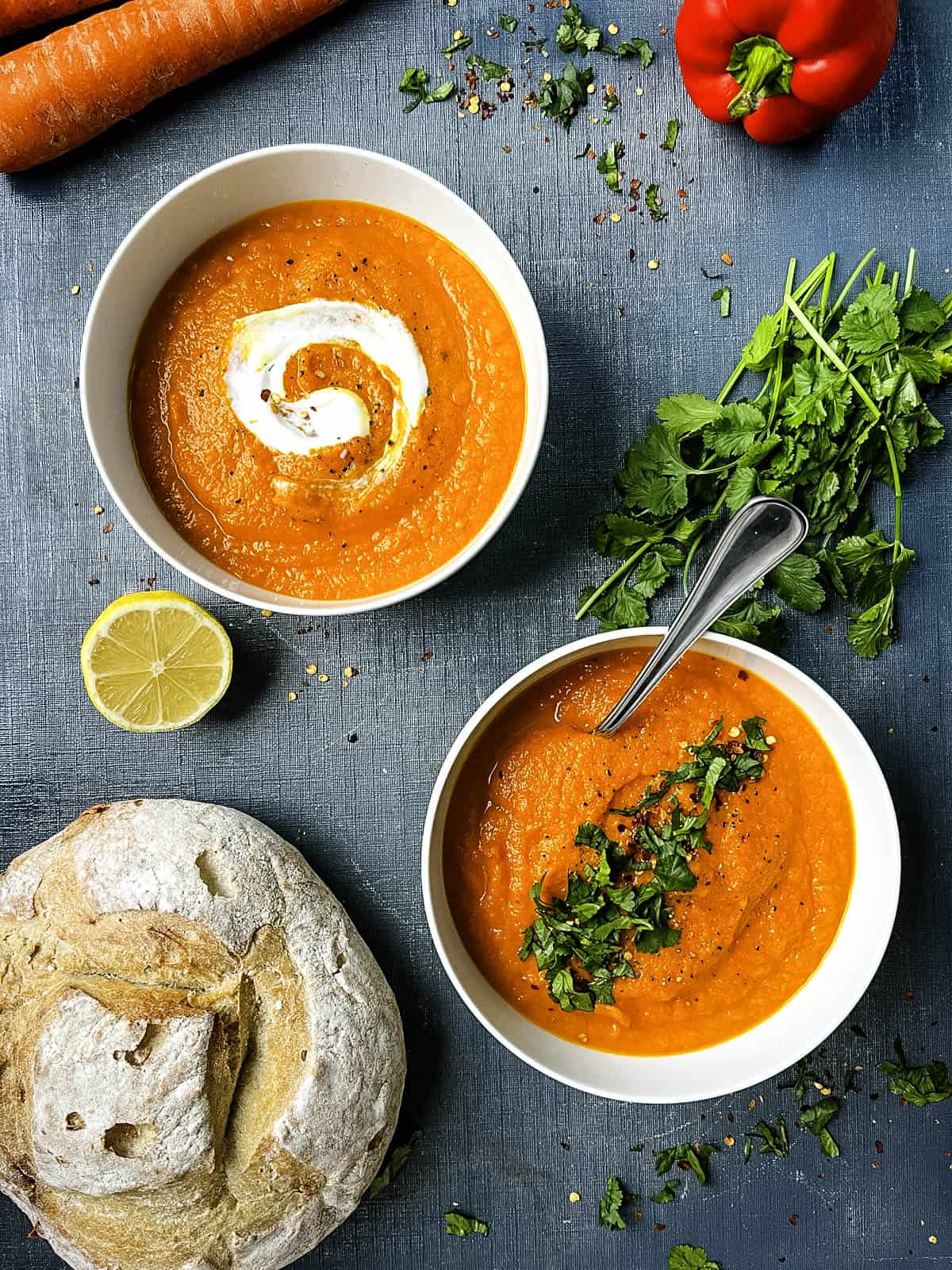 bowl of carrot and red pepper soup topped with coriander