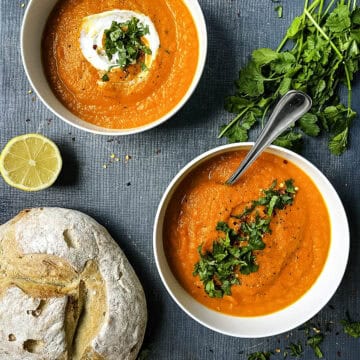 roasted carrot and red pepper soup with coriander topped with fresh herbs