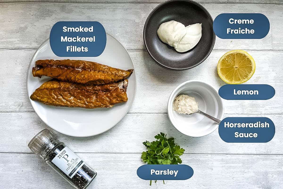 ingredients needed to make smoked mackerel pate, labelled, smoked mackerel fillets, creme fraiche, lemon, horseradish sauce, black pepper, fresh parsley.