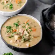 bowl of ham and potato soup topped with fresh parsley for leftover ham and gammon recipes.