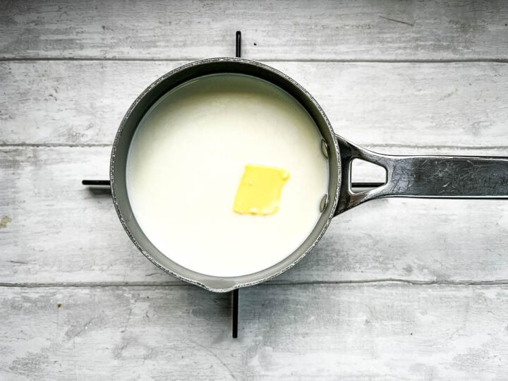milk, pudding rice, butter in pan ready for creamy rice pudding.