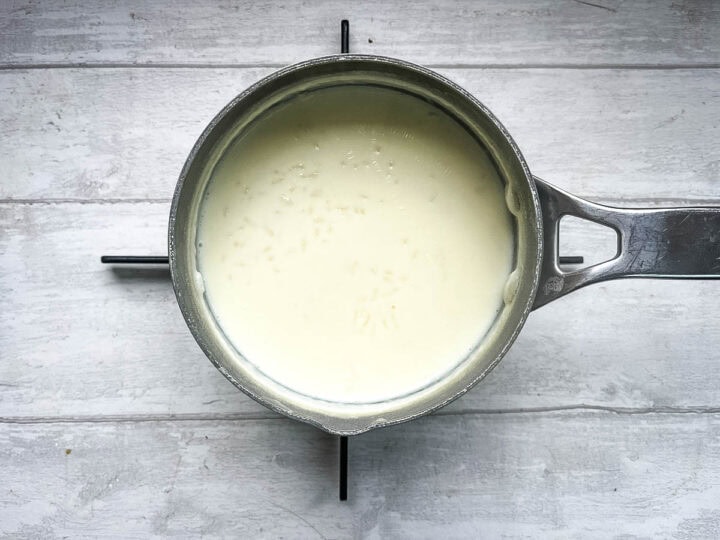 creamy rice pudding simmering on hob.