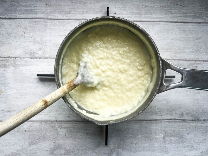 creamy rice pudding thickening on hob.