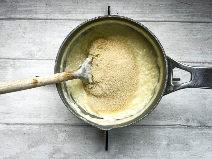 rice pudding in pan with sugar stirred through.