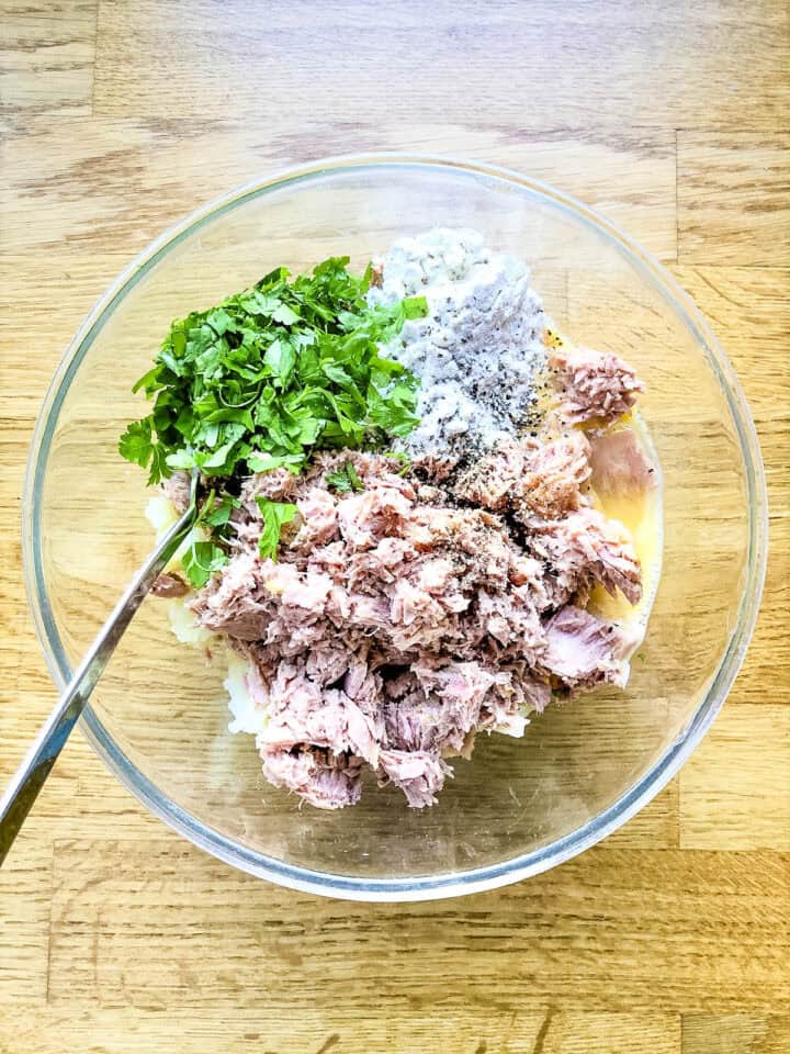 canned tuna egg flour and herbs in bowl.