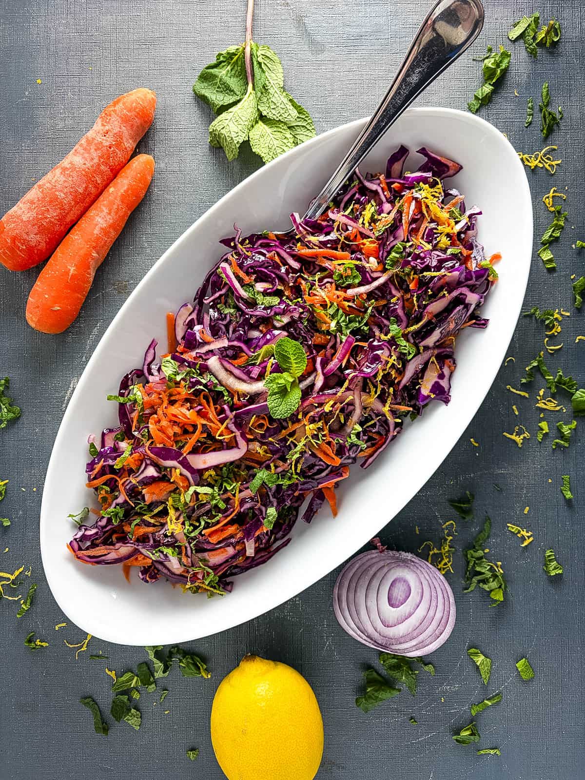 red cabbage salad with carrot and fresh mint topped with lemon zest.