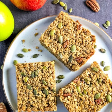 apple flapjack slices with pumpkin seeds on a plate.
