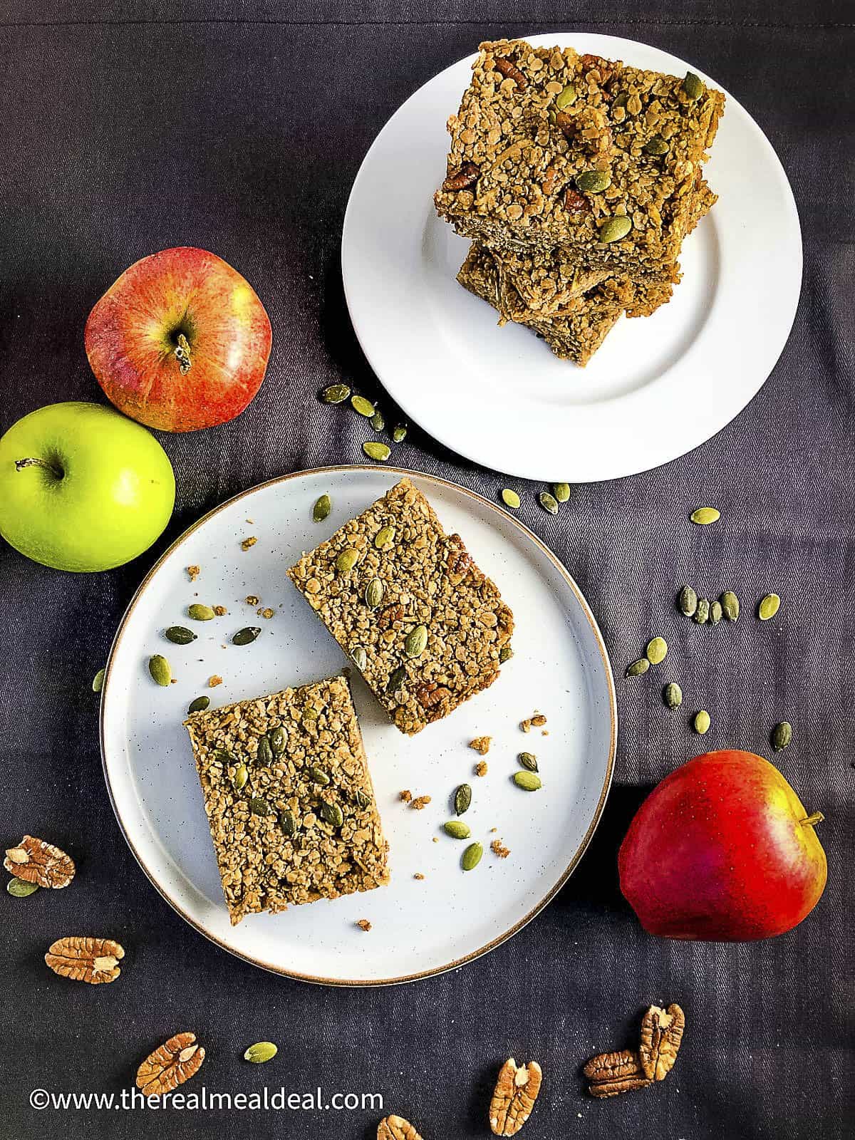 apple flapjack slices with eating apples, pumpkin seeds and pecan nuts.