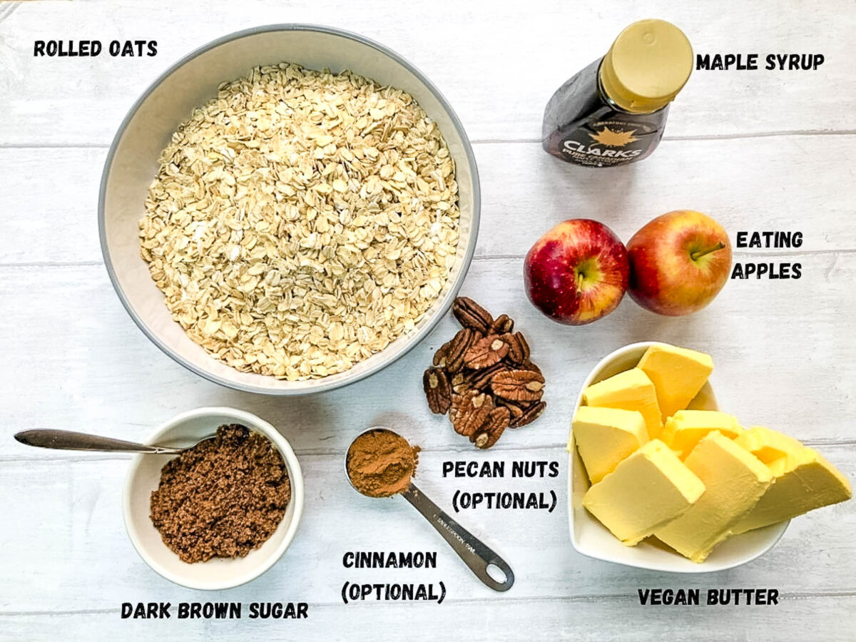ingredients for apple flapjacks, rolled oats, maple syrup, apples, pecan nuts, butter (vegan), cinnamon, dark brown sugar