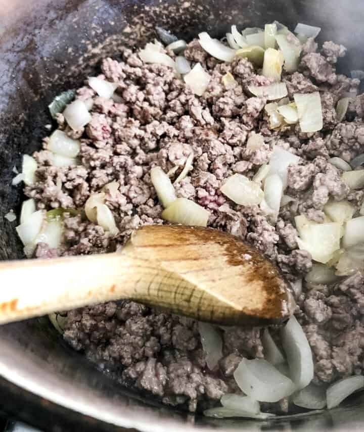 lamb mince and onions frying in pan.