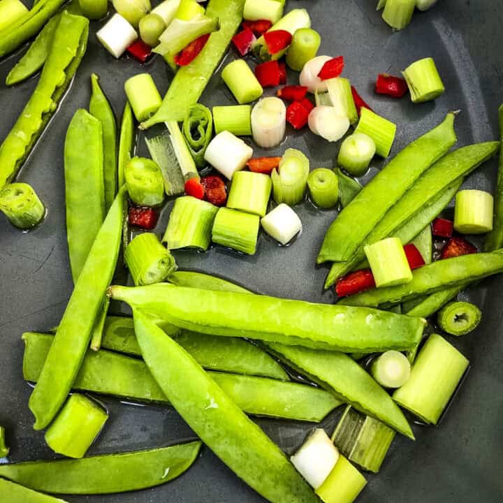 crunchy vegetables frying in pan for smoked mackerel salad.