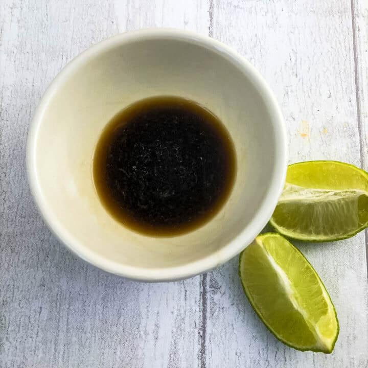 soy sauce and lime juice in bowl as dressing for smoked mackerel salad.
