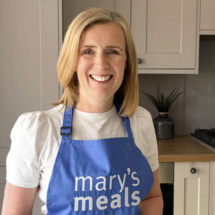 claire carter founder of The Real Meal Deal with Mary's Meals apron as sign of corporate sponsorship deal