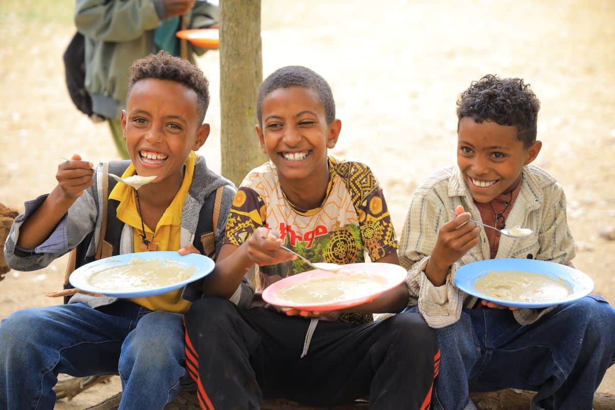 three boys eating mary's meals