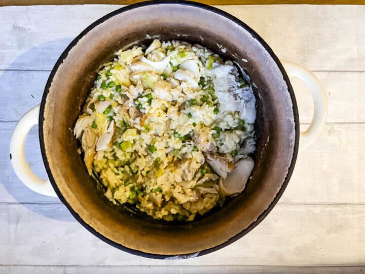 smoked haddock risotto with leek and peas resting in pan